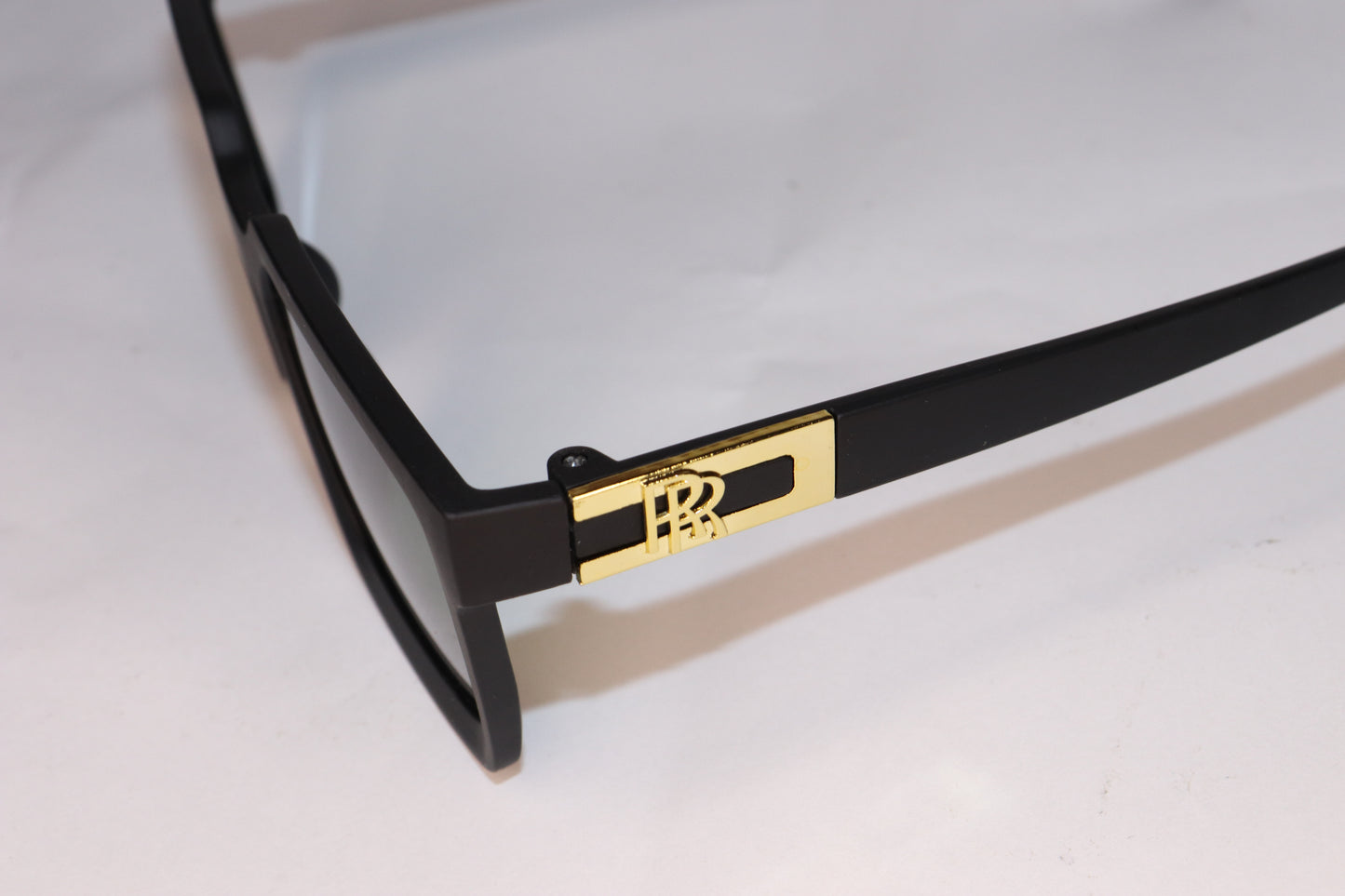 Black sunglasses with green lenses