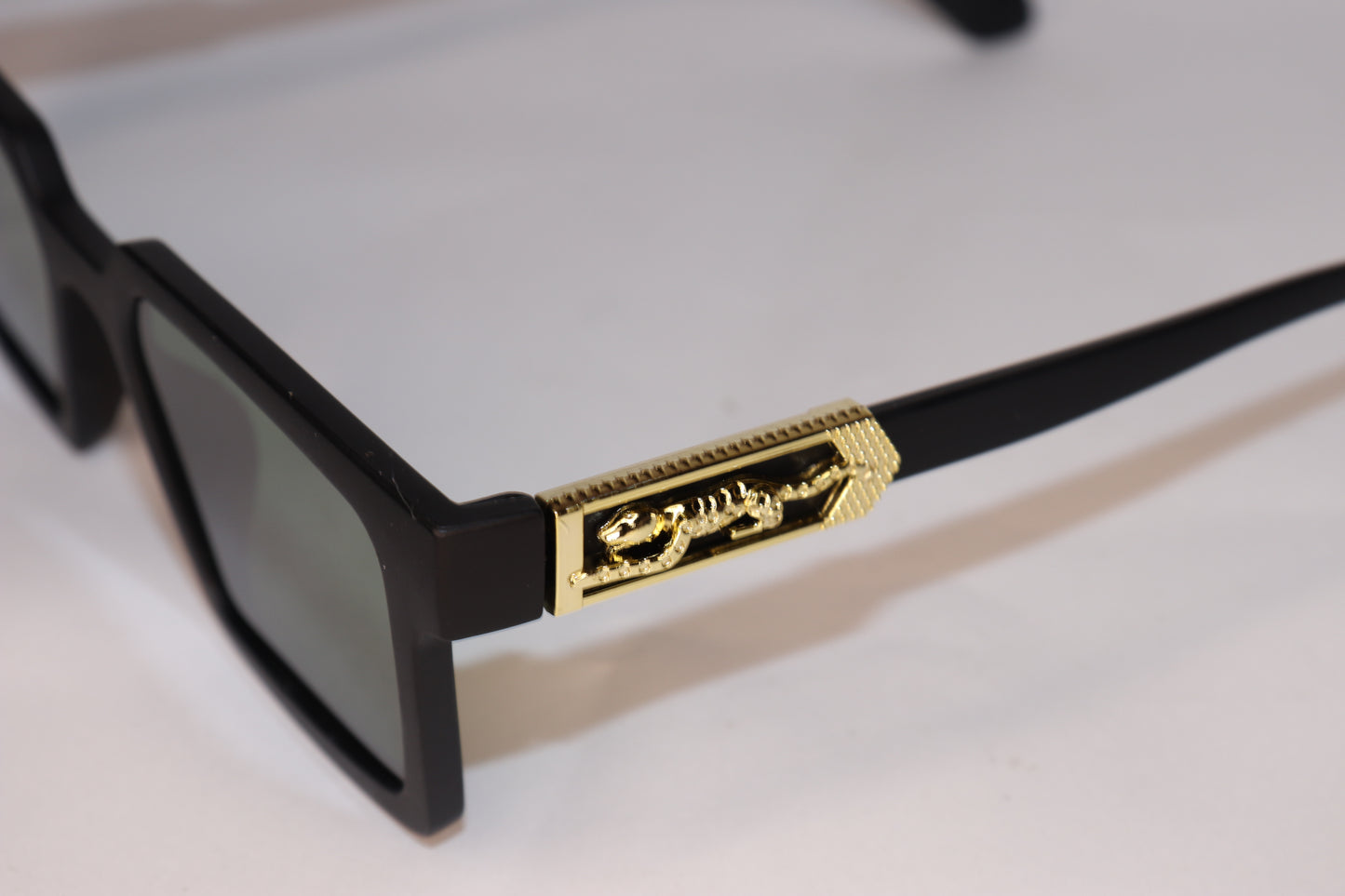 Black sunglasses with gold accents