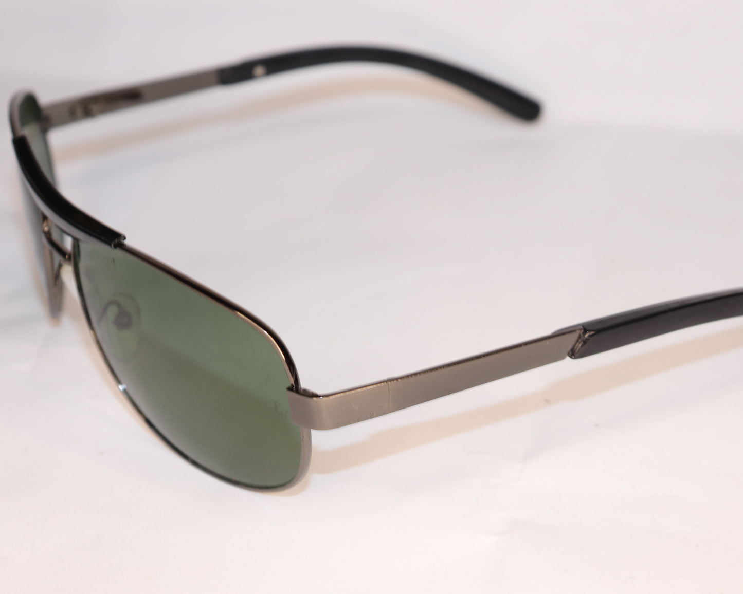 Sunglasses with black frame and green lenses