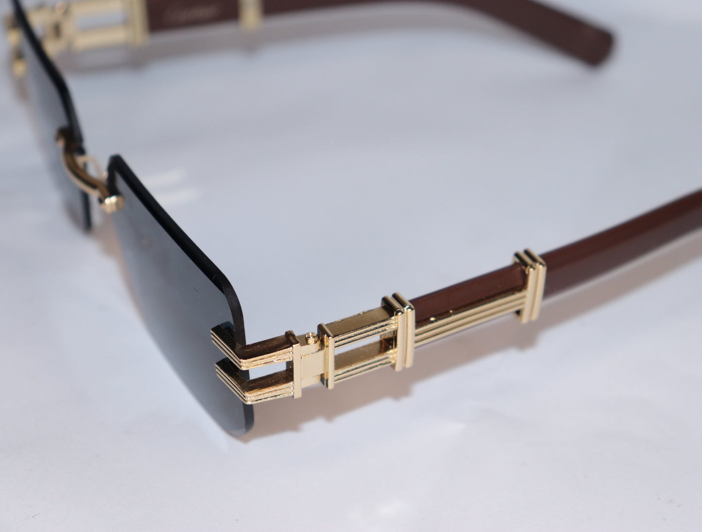 Gold-framed sunglasses with dark lenses