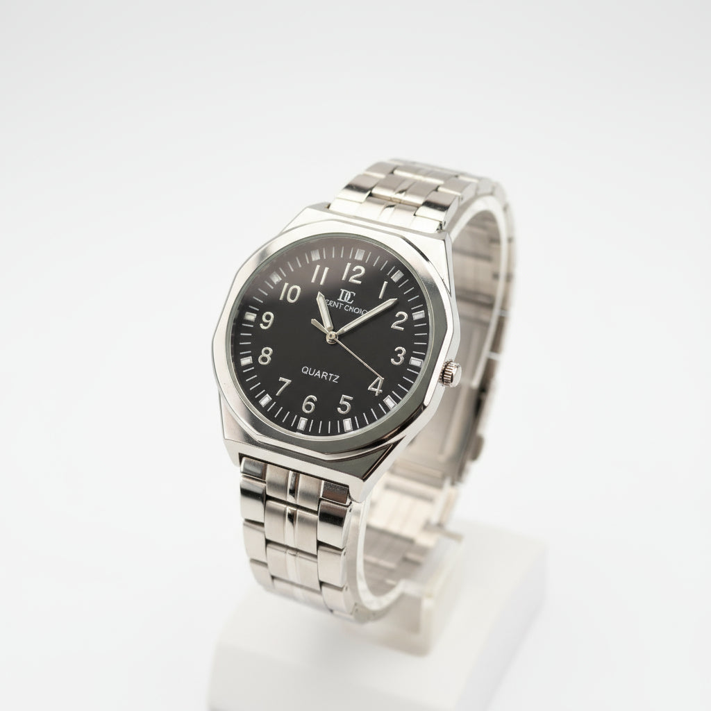 Silver watch with a black face on a light gray background