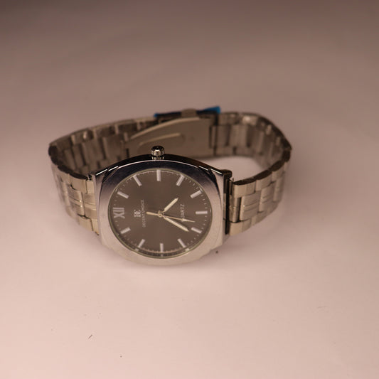 Wristwatch with metal band on a beige background