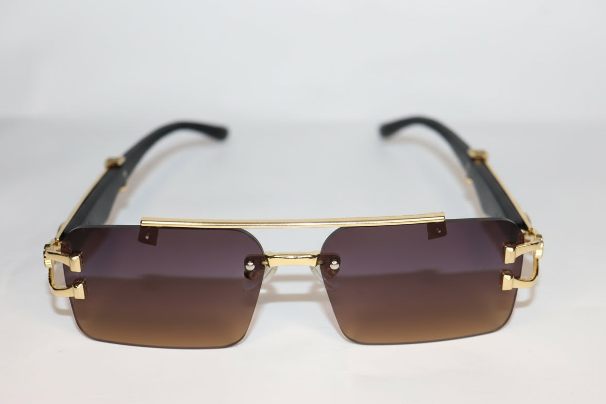 Gold-framed sunglasses with intricate design