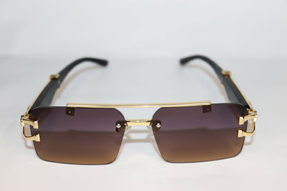 Gold-framed sunglasses with intricate design