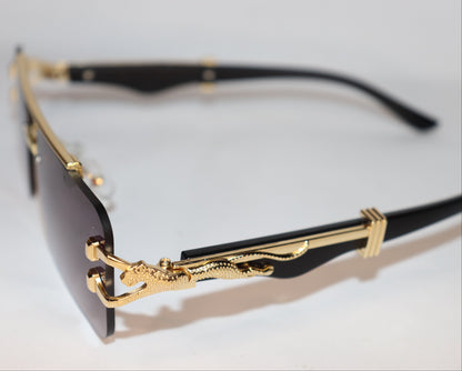 Gold-framed sunglasses with intricate design