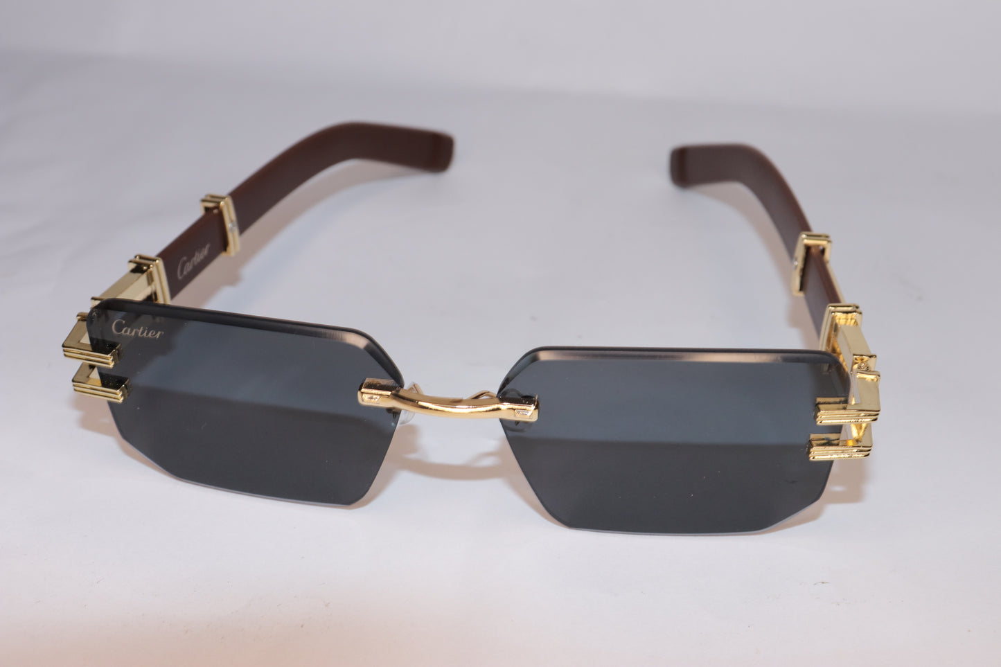 Gold-framed sunglasses with dark lenses
