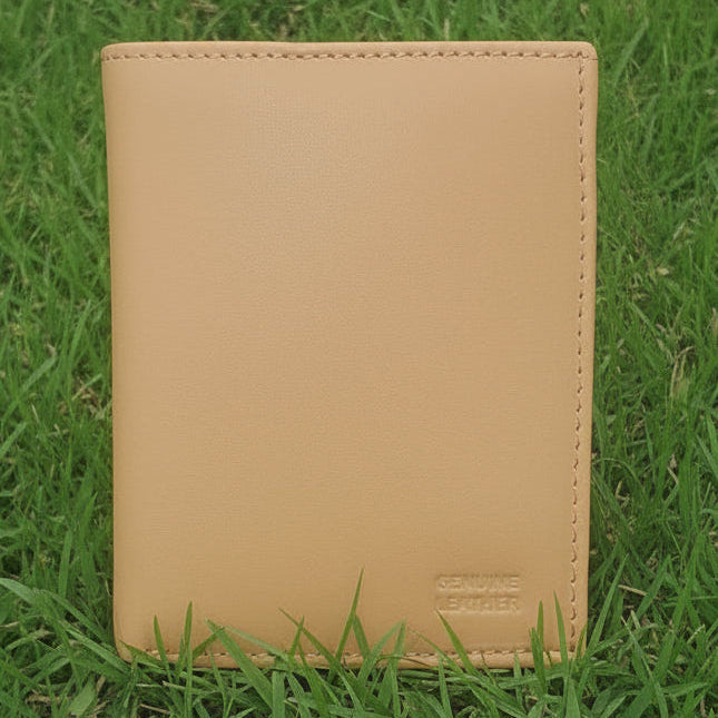 Beige leather wallet on a grass background